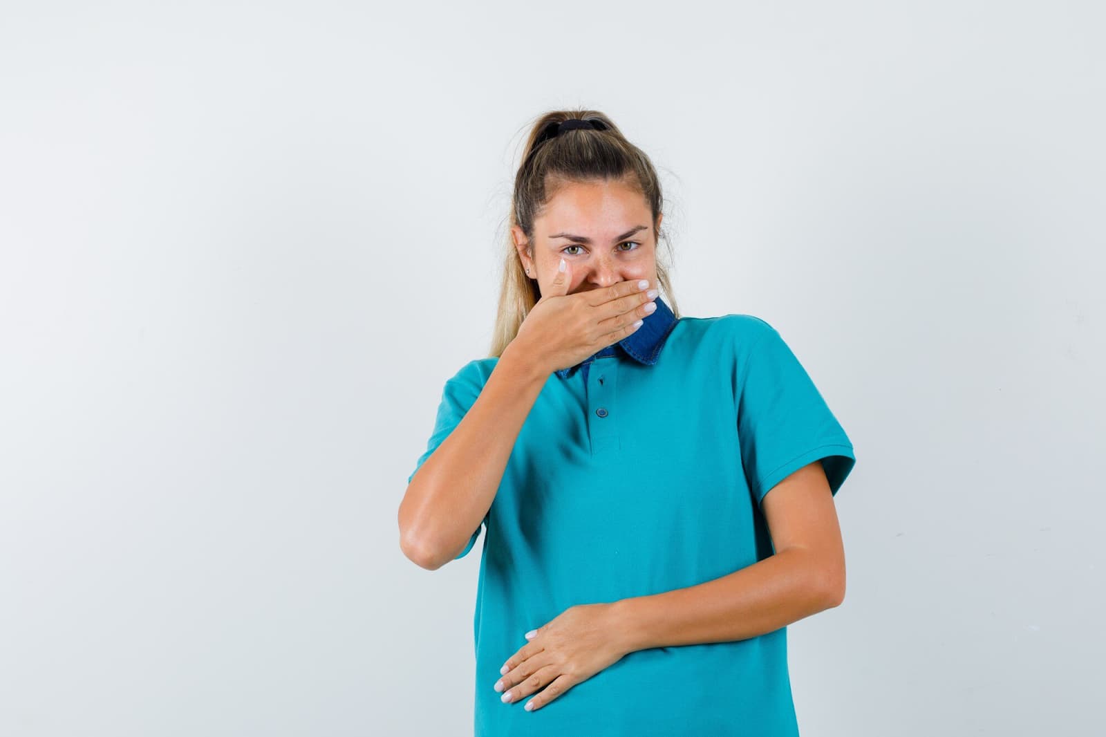 The girl holds her liver and covers her mouth with her hand