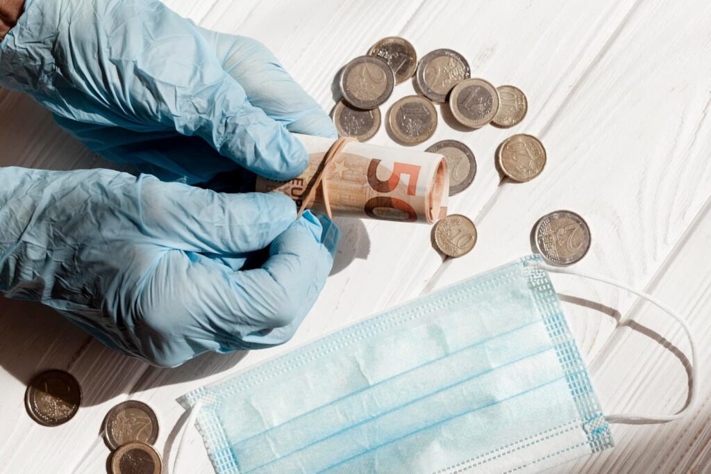 Money with protection gloves and medical mask