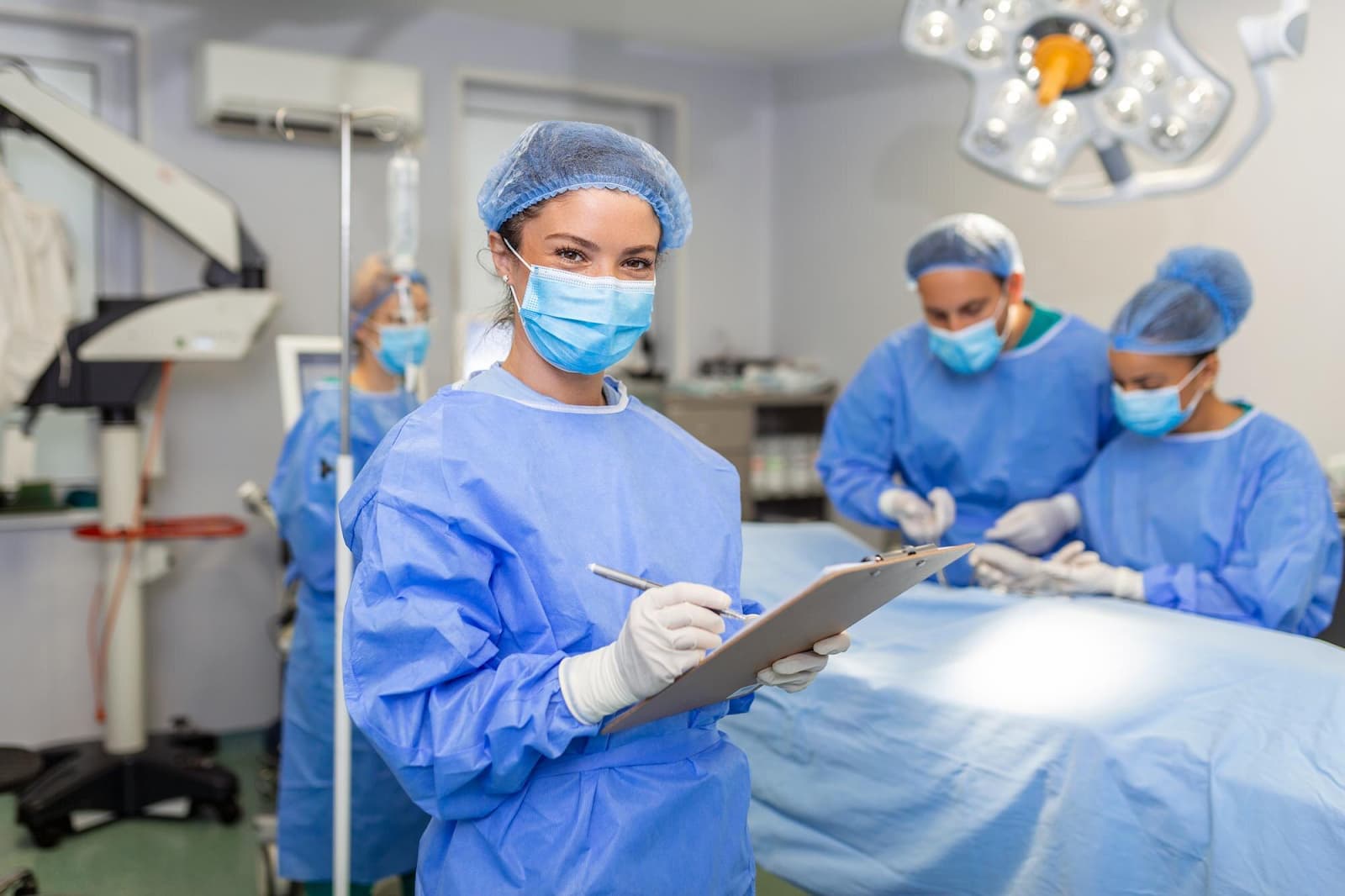 Surgeon writing on clipboard in operation room