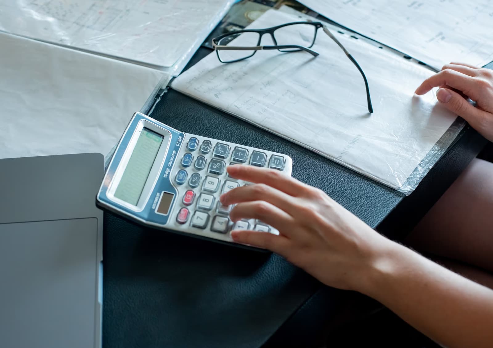 Close-up view of female hands doing calculations