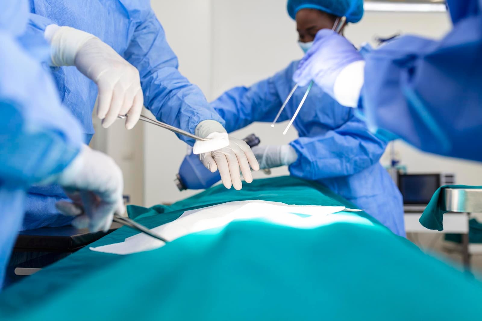 A team of surgeons in uniform performs an operation on a patient