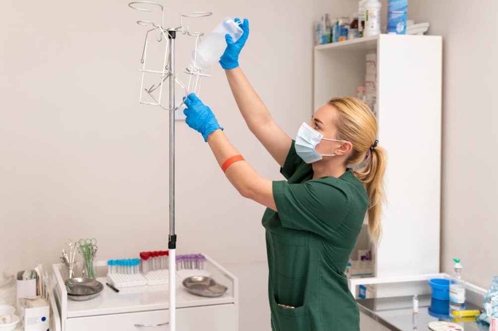 A nurse preparing an IV bag in a clinic