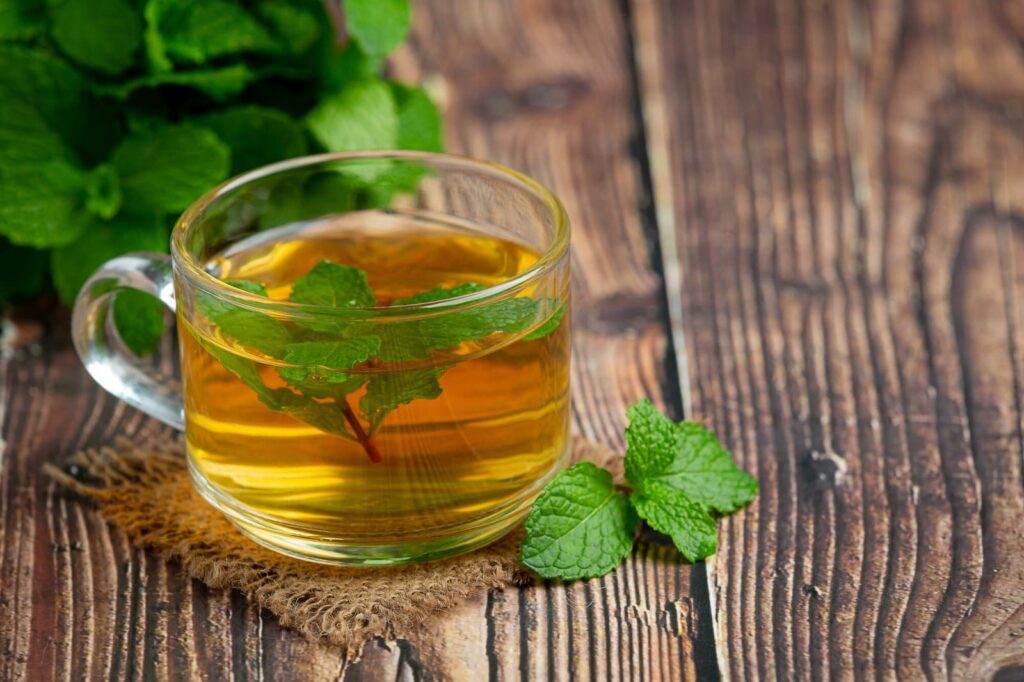 Cup of green tea on wooden table