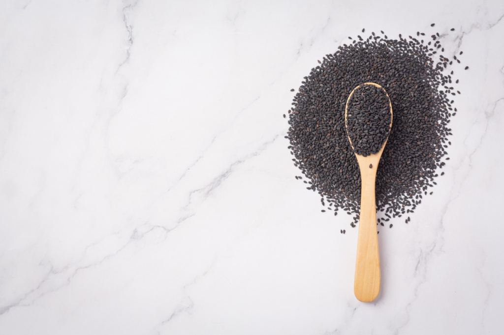 Black seeds on marble background