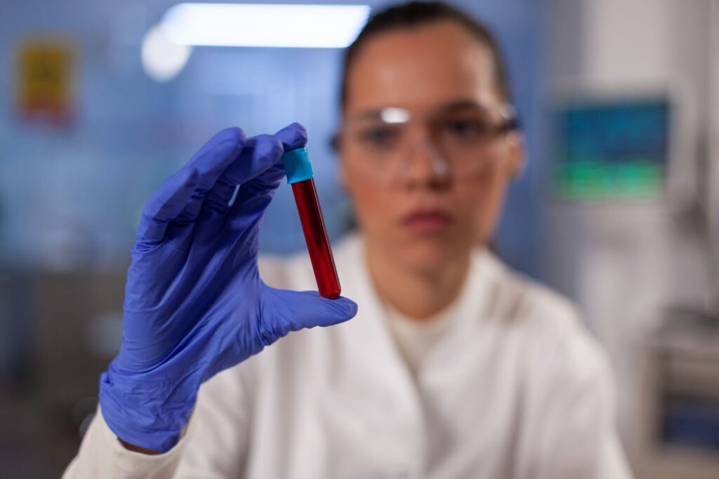 Scientific research doctor holding test tube with blood