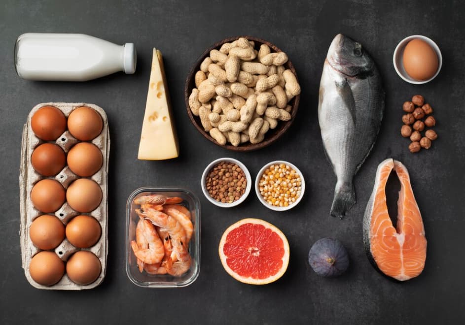 Assorted high-protein foods on a dark surface